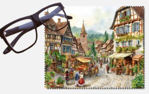 Lots of people in an olden days town with a cobble road lens cleaning cloth